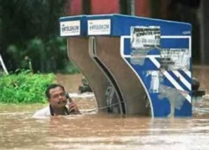 for during while grammar A man is using a phone while the flood water around him is rising.