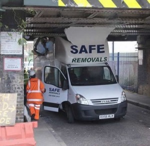 neither am I or either am I A van from a company called safe removals has crashed into a low bridge.